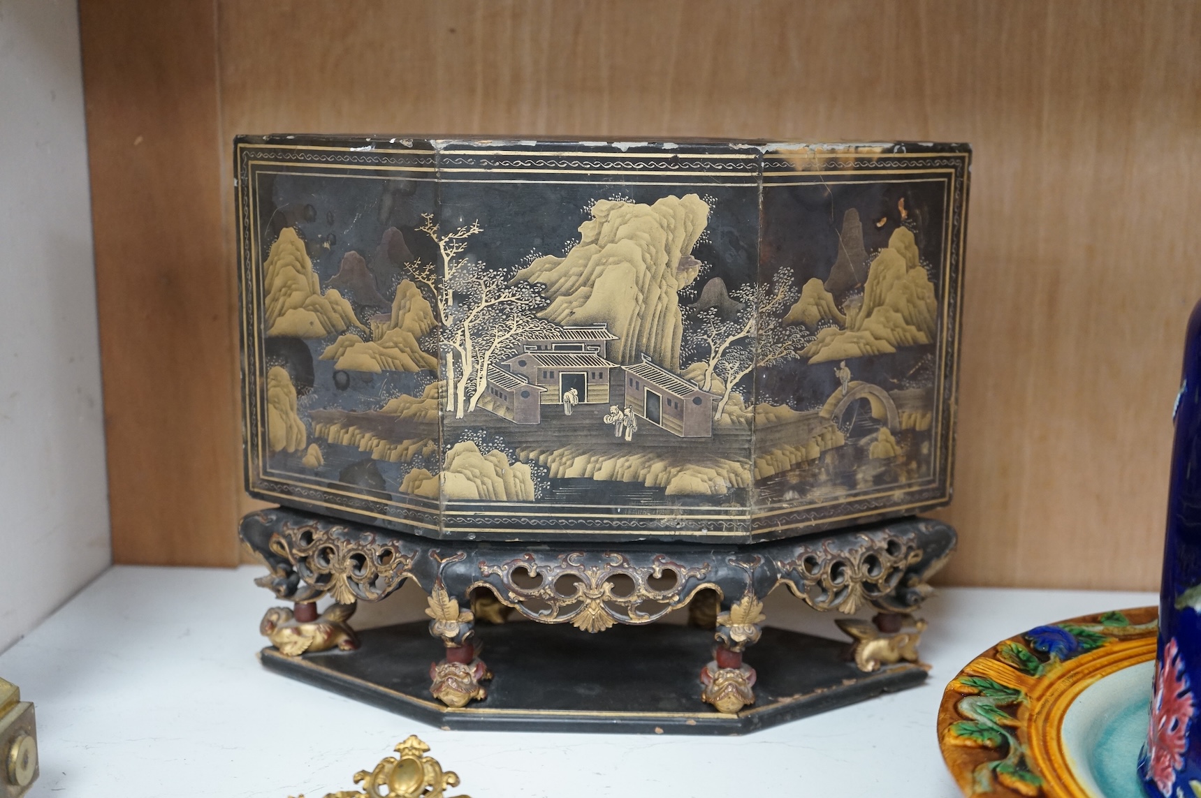 A Chinese lacquered and carved wood temple ornament, 26.5cm high, 32cm widest on base.
